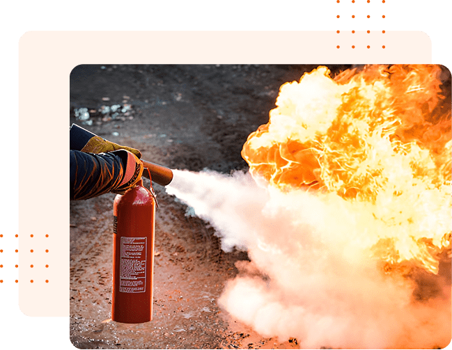 Person extinguishing a fire with a fire extinguisher.